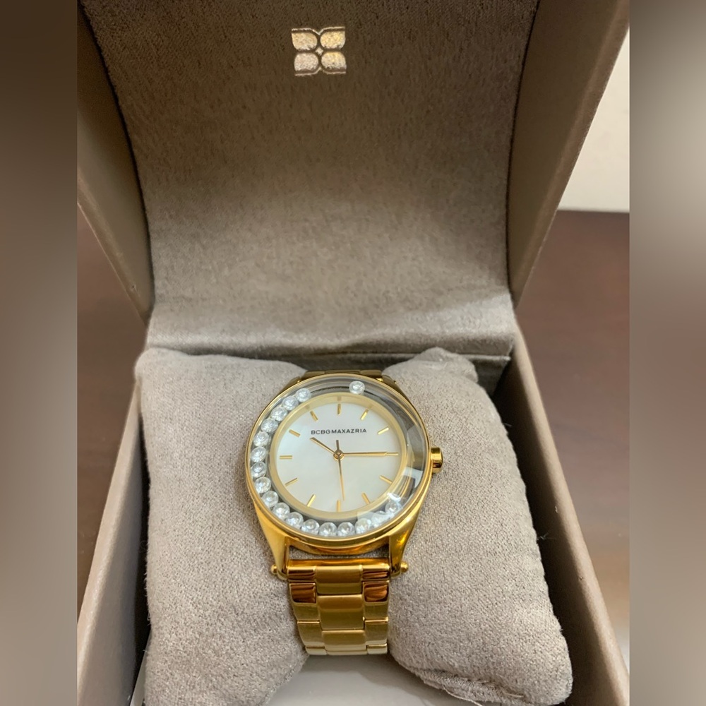 BCBGMaxAzria gold tone watch with pearl face and floating crystals